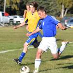 Cook Inlet striker Hunter Moos takes the ball downfield with Tri-Valleys Louis Overington (7) defending Thursday evening at the Kenai Sports Complex. (Photo by Joey Klecka/Peninsula Clarion)