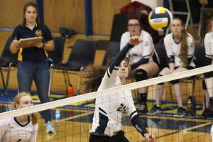Homers Marina Carroll spikes the ball over the net during a game against Kenai Central High School on Thursday, Sept. 13, 2018 at Homer High School in Homer, Alaska. The Mariners beat the Kardinals three games to one in the Southcentral Conference match-up. (Photo by Megan Pacer/Homer News)