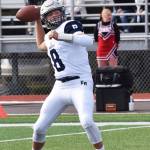 Eagle River quarterback Ryan Adkins winds up for a throw Saturday against Kenai Central at Ed Hollier Field in Kenai. (Photo by Joey Klecka/Peninsula Clarion)