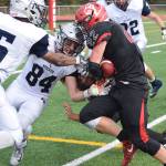 Eagle River defender Mason Piper (84) attempts to knock the ball free from the grasp of Kenais Titus Riddall (22) Saturday at Ed Hollier Field in Kenai. (Photo by Joey Klecka/Peninsula Clarion)
