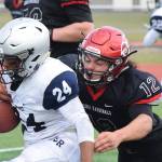 Kenai defender Tyrone McEnerney tackles Eagle Rivers Kobe Sherman (24) Saturday at Ed Hollier Field in Kenai. (Photo by Joey Klecka/Peninsula Clarion)