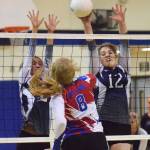 Soldotna teammates Carsen Brown (left) and Bailey Leach combine to put a block on Anchorage Christians Morgan Merriner (8) Friday night at the Soldotna Prep gym. (Photo by Joey Klecka/Peninsula Clarion)