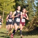 Kenai Centrals Jaycie Calvert leads Grace Christians Mazzy Jackson, and Kenai Centrals Brooke Satathite and Summer Foster, early in the Division II girls race at the Region 3 meet Saturday, Sept. 22, 2018, at Tsalteshi Trails. (Photo by Jeff Helminiak/Peninsula Clarion)