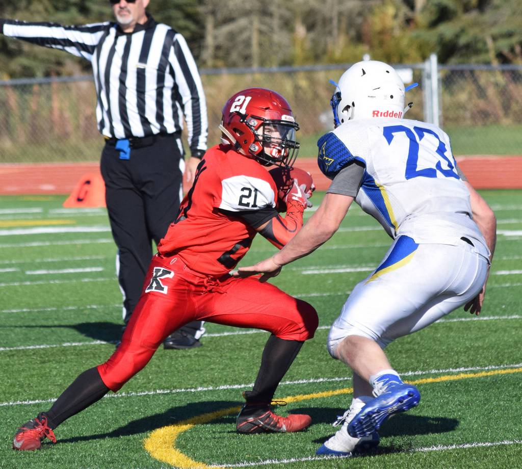 Kenais Zach Burnett (left) evades a tackle by Kodiaks Micah Bartel Saturday afternoon against Kodiak at Kenais Ed Hollier Field. (Photo by Joey Klecka/Peninsula Clarion)