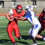 Kenais Tyrone McEnerney sheds a tackle from a Kodiak defender Saturday afternoon at Kenais Ed Hollier Field. (Photo by Joey Klecka/Peninsula Clarion)