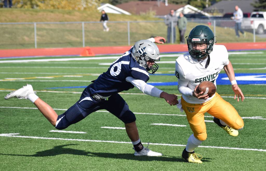 Soldotnas Zach Zeigler chases Service quarterback Jason Villanueva-Kaeo, Saturday afternoon at Soldotnas Justin Maile Field. (Photo by Joey Klecka/Peninsula Clarion)