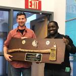 Nikiski firefighters Levi Doss (left) and Harrison Deveer hold up an award presented to Doss for service and dedication in an undated photo. Doss medically retired from the Nikiski Fire Department after he was diagnosed with brain cancer. (Photo provided by Tera Doss)