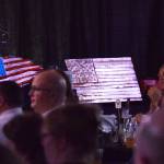 A pair of American flag design wall plaques sit on stage Friday night at the Alaska Fire Conference in the Kenai Center mall. (Photo by Joey Klecka/Peninsula Clarion)