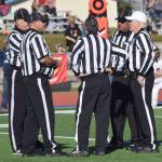 Randy Sparks, far right, confers with his officiating crew Saturday, Sept. 29, 2018, during the Soldotna-Kenai Central game at Justin Maile Field in Soldotna. After 22 years, Sparks was officiating his late game on the Kenai Peninsula. (Photo by Jeff Helminiak/Peninsula Clarion)