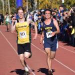 Sewards Max Pfeiffenberger (left) and Homers Bill Rich race for 16th place in the Division II boys race Saturday at the ASAA state cross-country running championships at the Bartlett Trails in Anchorage. (Photo by Joey Klecka/Peninsula Clarion)