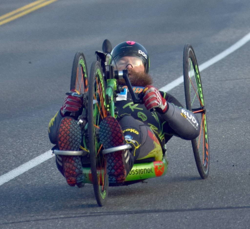 Anchorage handcyclist Ira Edwards cruises down Bridge Access Road on Sunday, Sept. 30, 2018, during the Kenai River Marathon. (Photo by Jeff Helminiak/Peninsula Clarion)