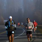 Michael Eriks of Carterville, Illinois, leads a pack of Kenai River Marathon racers through the early morning fog on Sunday, Sept. 30, 2018, on Bridge Access Road. (Photo by Jeff Helminiak/Peninsula Clarion)
