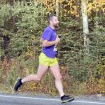 Sewards Patrick Lewis strides down Beaver Loop Road on the way to a runner-up finish in the half marathon of the Kenai River Marathon on Sunday, Sept. 30, 2018. (Photo by Jeff Helminiak/Peninsula Clarion)
