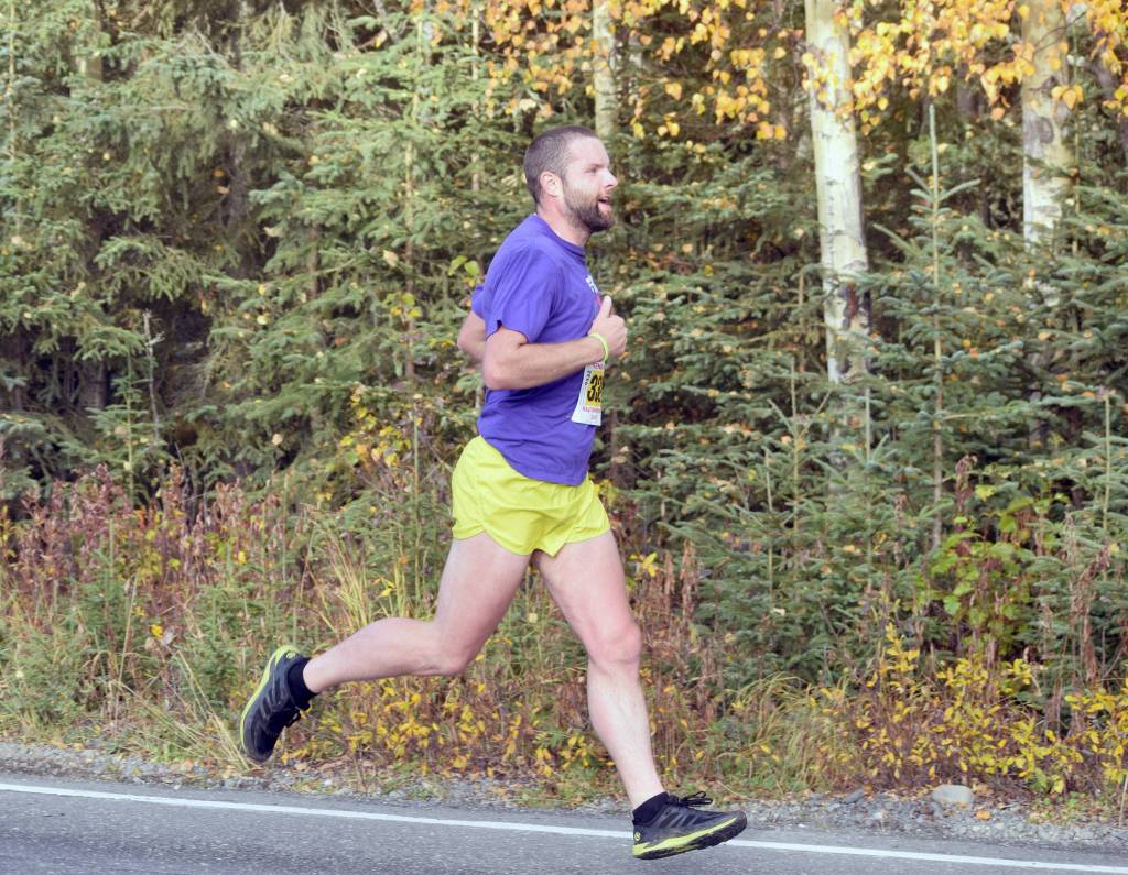 Sewards Patrick Lewis strides down Beaver Loop Road on the way to a runner-up finish in the half marathon of the Kenai River Marathon on Sunday, Sept. 30, 2018. (Photo by Jeff Helminiak/Peninsula Clarion)