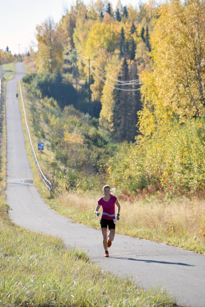Palmers Christy Marvin climbs the last big hill on the Kenai Spur Highway on the way to victory in the womens Kenai River Marathon on Sunday, Sept. 30, 2018. (Photo by Jeff Helminiak/Peninsula Clarion)