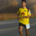 Homers Pedro Ochoa runs on Bridge Access Road on the way to victory in the Kenai River Marathon on Sunday, Sept. 30, 2018. (Photo by Jeff Helminiak/Peninsula Clarion)