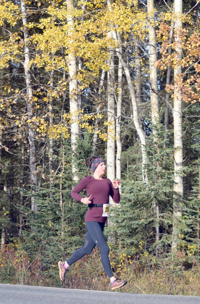 Eagle Rivers Victoria Oxetenko floats down Beaver Loop Road on the way to victory in the half marathon of the Kenai River Marathon on Sunday, Sept. 30, 2018. (Photo by Jeff Helminiak/Peninsula Clarion)