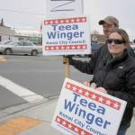 Kenai City Council candidate Teea Winger and her husband hold campaign signs for passing motorists along the Kenai Spur Highway on Tuesday, Oct. 2, 2018 in Kenai, Alaska. (Photo by Erin Thompson/Peninsula Clarion)