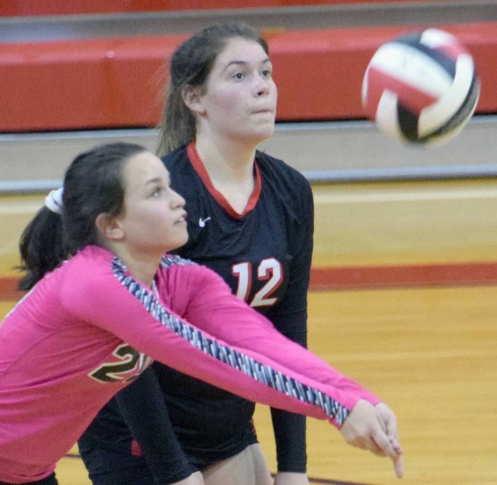 Kenai Centrals Jenna Streiff bumps in front of Kaylee Lauritsen on Tuesday, Oct. 2, 2018, at Kenai Central High School. (Photo by Jeff Helminiak/Peninsula Clarion)