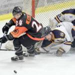 Kenai River Brown Bears forward Zach Krajnik tries to score late in the first period but is blocked by Springfield (Illinois) Jr. Blues defenseman Fletcher Fineman and goalie Evan Fear last season at the Soldotna Regional Sports Complex. (Photo by Jeff Helminiak/Peninsula Clarion)