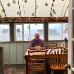 Sean Dusek waits to talk and answer the publics questions in the back room of Veronicas Cafe in Kenai on Friday. (Photo by Victoria Petersen/Peninsula Clarion)