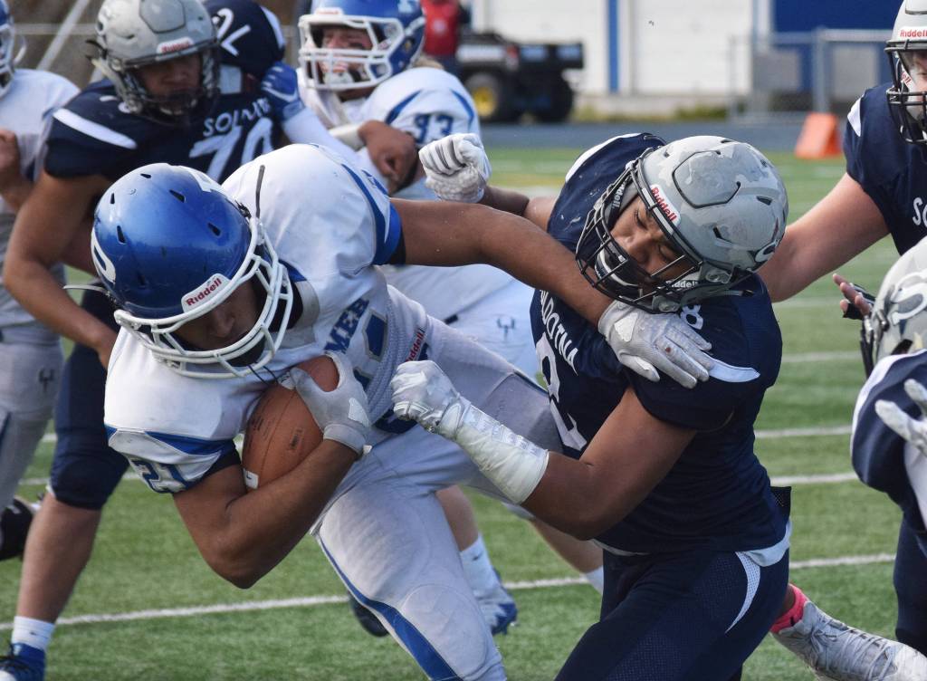 Soldotna junior Aaron Faletoi (right) tackles Palmer junior Lavar Marshall in a Division II state semifinal game Saturday afternoon at Palmers Machetanz Field. (Photo by Joey Klecka/Peninsula Clarion)