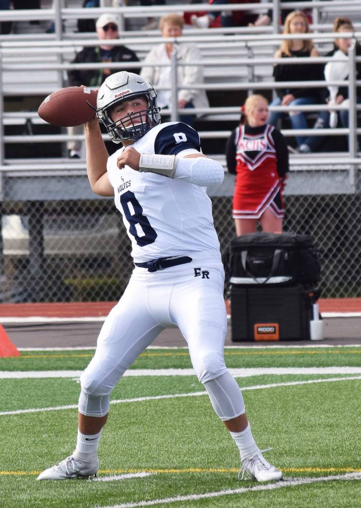 Eagle River quarterback Ryan Adkins winds up for a throw Sept. 15, 2018, against Kenai Central at Ed Hollier Field in Kenai. (Photo by Joey Klecka/Peninsula Clarion)