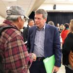 Democratic nominee for governor in Alaska Mark Begich, center, speaks to a man following a candidate forum on Tuesday, Oct. 2, 2018, in Juneau, Alaska. Also attending the forum were Gov. Bill Walker, an independent, and Libertarian Billy Toien. (AP Photo/Becky Bohrer)