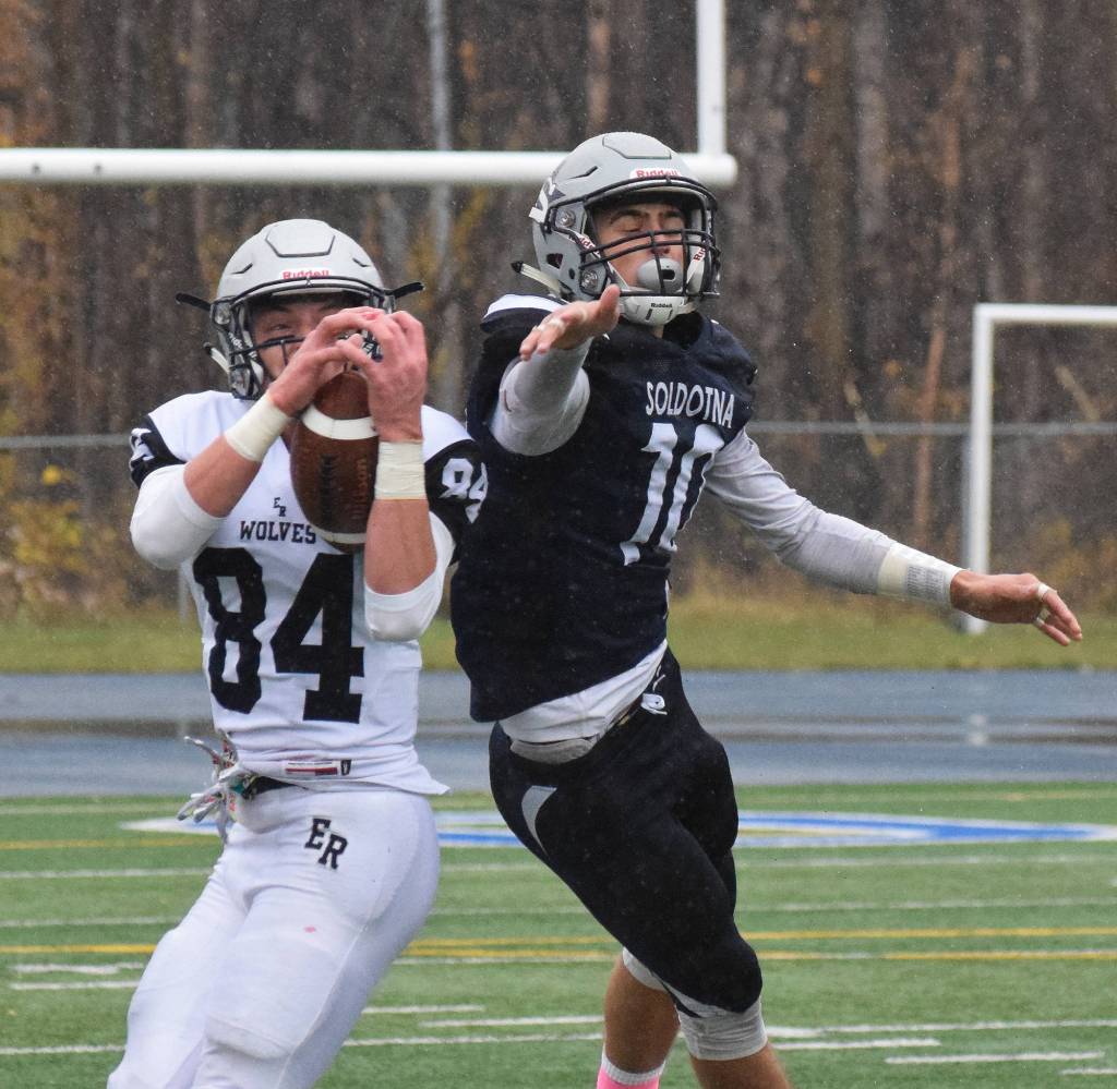 Eagle River receiver Mason Piper hauls in a catch as Soldotna defensive back Cy Updike attempts to block it Saturday in the Division II state football championship game at Machetanz Field in Palmer. (Photo by Joey Klecka/Peninsula Clarion)