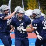 Soldotna running back Brenner Furlong (center) receives congratulations from teammates Zach Hanson (left) and Aaron Faletoi (right) after scoring a touchdown Sept. 16, 2017, at Justin Maile Field in Soldotna. (Photo by Joey Klecka/Peninsula Clarion)