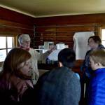 Marge Mullen shows a group of third graders around the Howard Lee Homestead, which was used as the citys first post office when she first homesteaded in Soldotna, on Wednesday, Oct. 17, 2018, in Soldotna, AK. (Photo by Victoria Petersen/Peninsula Clarion)