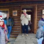 Marge Mullen shows a group of third graders around the Howard Lee Homestead, which was used as the citys first post office when she first homesteaded in Soldotna, on Wednesday, Oct. 17, 2018, in Soldotna, AK. (Photo by Victoria Petersen/Peninsula Clarion)