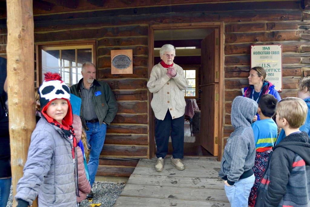 Marge Mullen shows a group of third graders around the Howard Lee Homestead, which was used as the citys first post office when she first homesteaded in Soldotna, on Wednesday, Oct. 17, 2018, in Soldotna, AK. (Photo by Victoria Petersen/Peninsula Clarion)