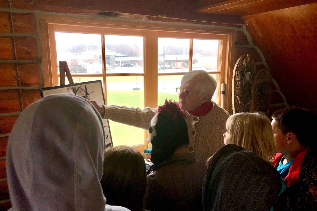 Marge Mullen shows a group of third graders around the Howard Lee Homestead, which was used as the citys first post office when she first homesteaded in Soldotna, on Wednesday, Oct. 17, 2018, in Soldotna, AK. (Photo by Victoria Petersen/Peninsula Clarion)