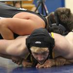 Antonin Murachev struggles to get out from under Nikiskis Simon Grenier during a dual meet Friday, Oct. 19, 2018, at Homer High School in Homer, Alaska. Grenier would go on to win the 152-pound weight class match. (Photo by Megan Pacer/Homer News)