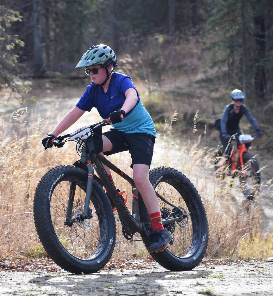 Soldotna youth rider Landon Showalter (front) leads mother Jen Showalter early in the Polar Vortex Cyclocross race Saturday at the Tsalteshi Trails in Soldotna. (Photo by Joey Klecka/Peninsula Clarion)