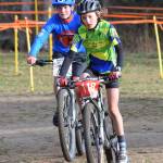 Anchorage youth rider Dara Stull leads Soldotna rider Dylan Hogue in the Polar Vortex Cyclocross race Saturday at the Tsalteshi Trails in Soldotna. (Photo by Joey Klecka/Peninsula Clarion)