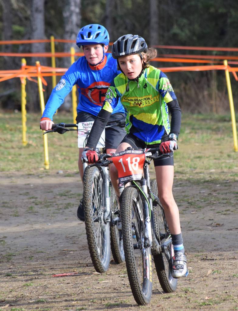 Anchorage youth rider Dara Stull leads Soldotna rider Dylan Hogue in the Polar Vortex Cyclocross race Saturday at the Tsalteshi Trails in Soldotna. (Photo by Joey Klecka/Peninsula Clarion)