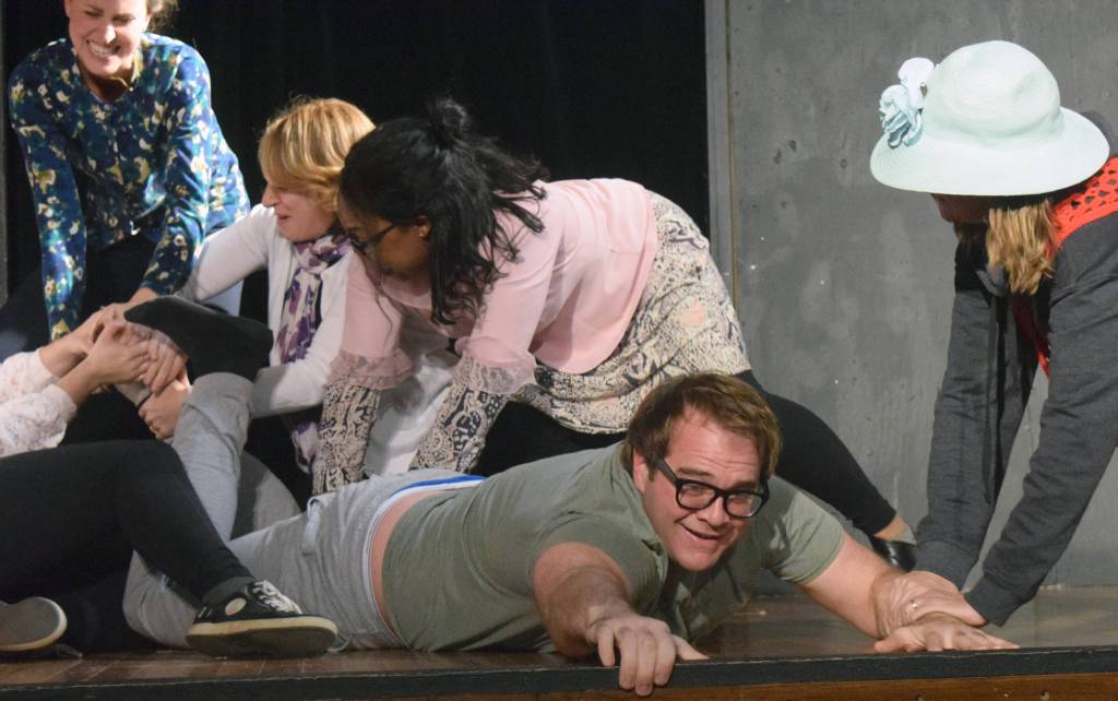 Chris Pepper is buttonholed by ladies working the voting booths in rehearsals for Lame Ducks and Dark Horses on Monday at Triumvirate North, five miles north of Kenai. (Photo by Jeff Helminiak/Peninsula Clarion)