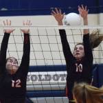 Kenai sophomore Abby Every (10) puts up a block with Kardinals teammate Kaylee Lauritsen against Soldotna, Thursday night at Soldotna High School. (Photo by Joey Klecka/Peninsula Clarion)