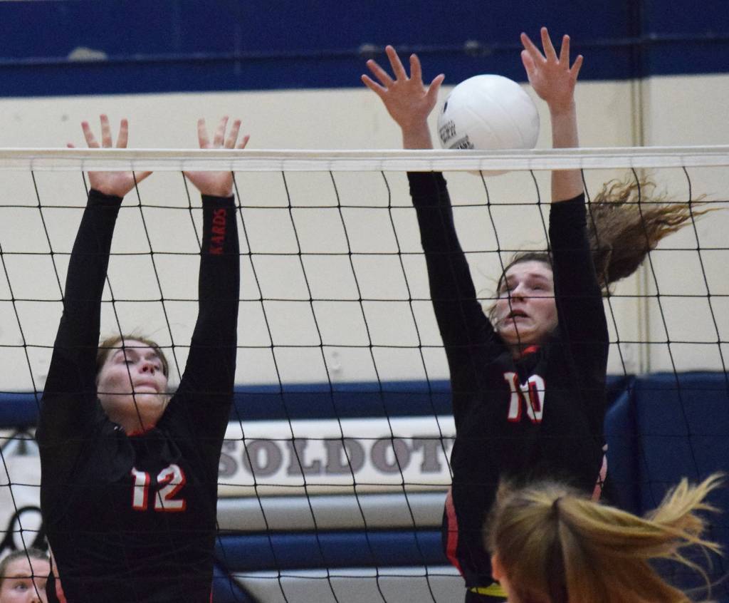 Kenai sophomore Abby Every (10) puts up a block with Kardinals teammate Kaylee Lauritsen against Soldotna, Thursday night at Soldotna High School. (Photo by Joey Klecka/Peninsula Clarion)