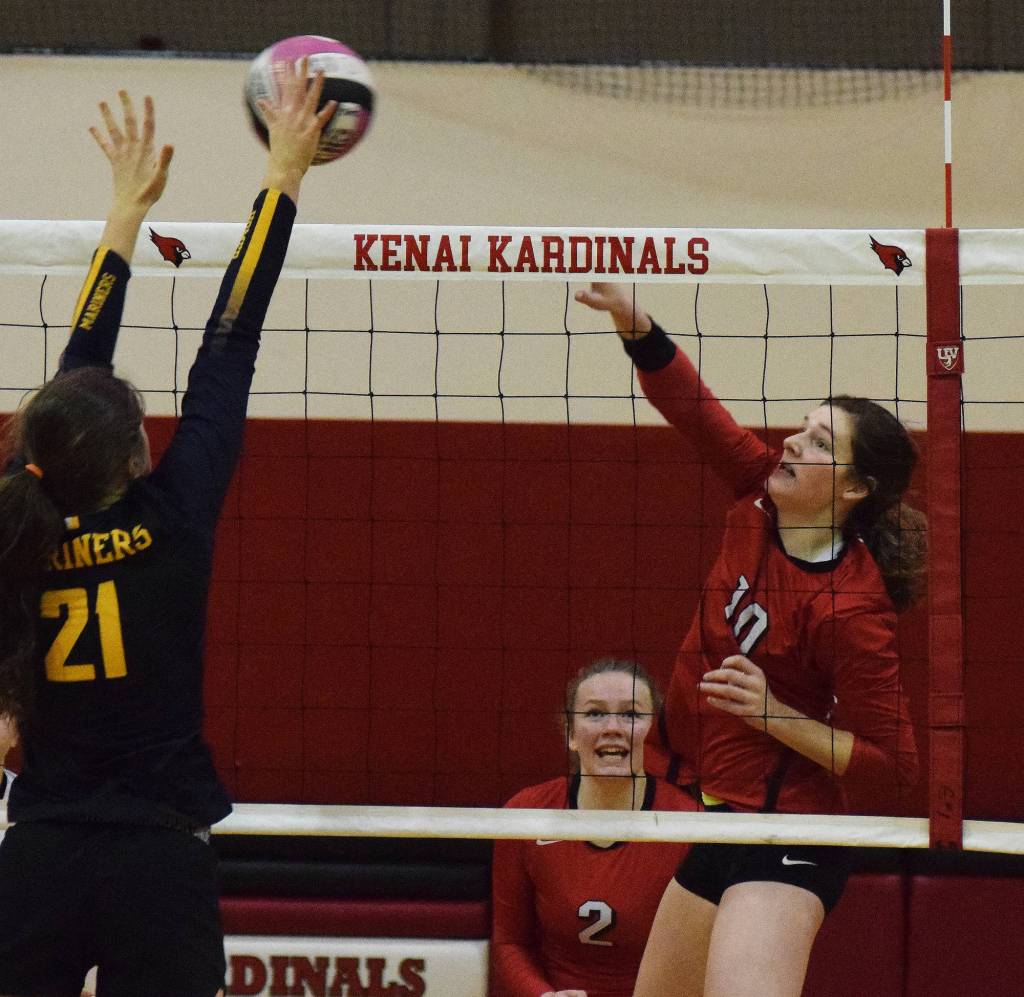Kenai sophomore Abby Every (10) sends a ball against the block of Homers Marina Carroll, Friday night at Kenai Central High School. (Photo by Joey Klecka/Peninsula Clarion)