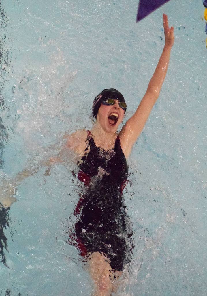 Kenais Mickinzie Ticknor pushes hard in the girls 100-yard backstroke B-final Saturday at the Northern Lights Conference championship swim meet at Homer High School. (Photo by Joey Klecka/Peninsula Clarion)