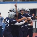 Soldotna junior Jersey Truesdell (pointing) is mobbed by teammates after scoring a touchdown Aug. 10, 2018, against West Anchorage at Justin Maile Field in Soldotna. (Photo by Joey Klecka/Peninsula Clarion)