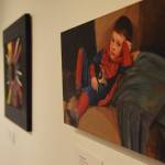 Paintings hang on the walls of the Kenai Fine Arts Center in advance of the Fact and Fiction showing that begins Thursday, Nov. 1, 2018 in Kenai, Alaska. (Photo by Joey Klecka/Peninsula Clarion)