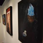 Paintings hang on the walls of the Kenai Fine Arts Center in advance of the Fact and Fiction showing that begins Thursday, Nov. 1, 2018 in Kenai, Alaska. (Photo by Joey Klecka/Peninsula Clarion)