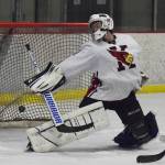 Kenai Central goaltender Carson Koppes attempts to block a shot by a North Pole skater Thursday night at the Peninsula Ice Challenge at the Kenai Multi-purpose Facility. (Photo by Joey Klecka/Peninsula Clarion)