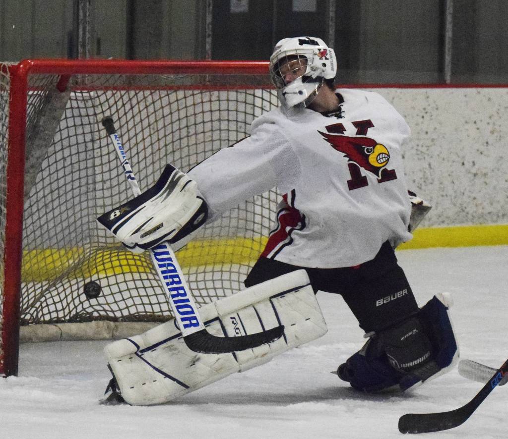 Kenai Central goaltender Carson Koppes attempts to block a shot by a North Pole skater Thursday night at the Peninsula Ice Challenge at the Kenai Multi-purpose Facility. (Photo by Joey Klecka/Peninsula Clarion)