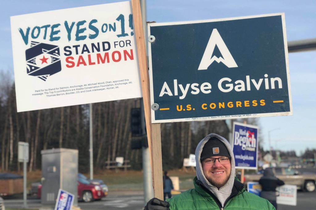 Nick Longobardi, a supporter of U.S. House District candidate Alyse Galvin holds signs at the intersection of the Sterling and Kenai Spur Highways on Tuesday, Nov. 6, 2018, in Soldotna, Alaska. (Photo by Victoria Petersen/Peninsula Clarion)