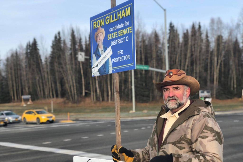 District O State Senate candidate Ron Gilliam holds a sign at the intersection of the Sterling and Kenai Spur Highways on Tuesday, Nov. 6, 2018, in Soldotna, Alaska. (Photo by Victoria Petersen/Peninsula Clarion)